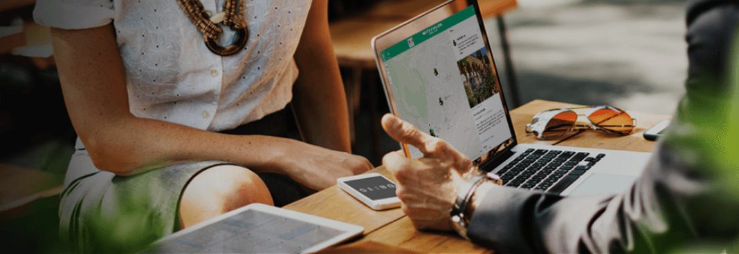 Footer banner with two people talking at desk