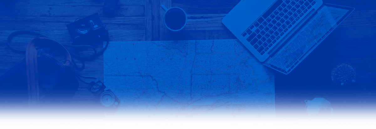 table with computer, map and other travel accessories